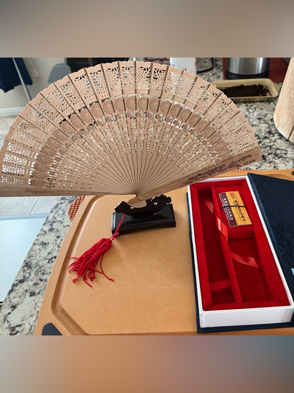 Carved Wood Folding Hand Fan in Tan with Red Tassel